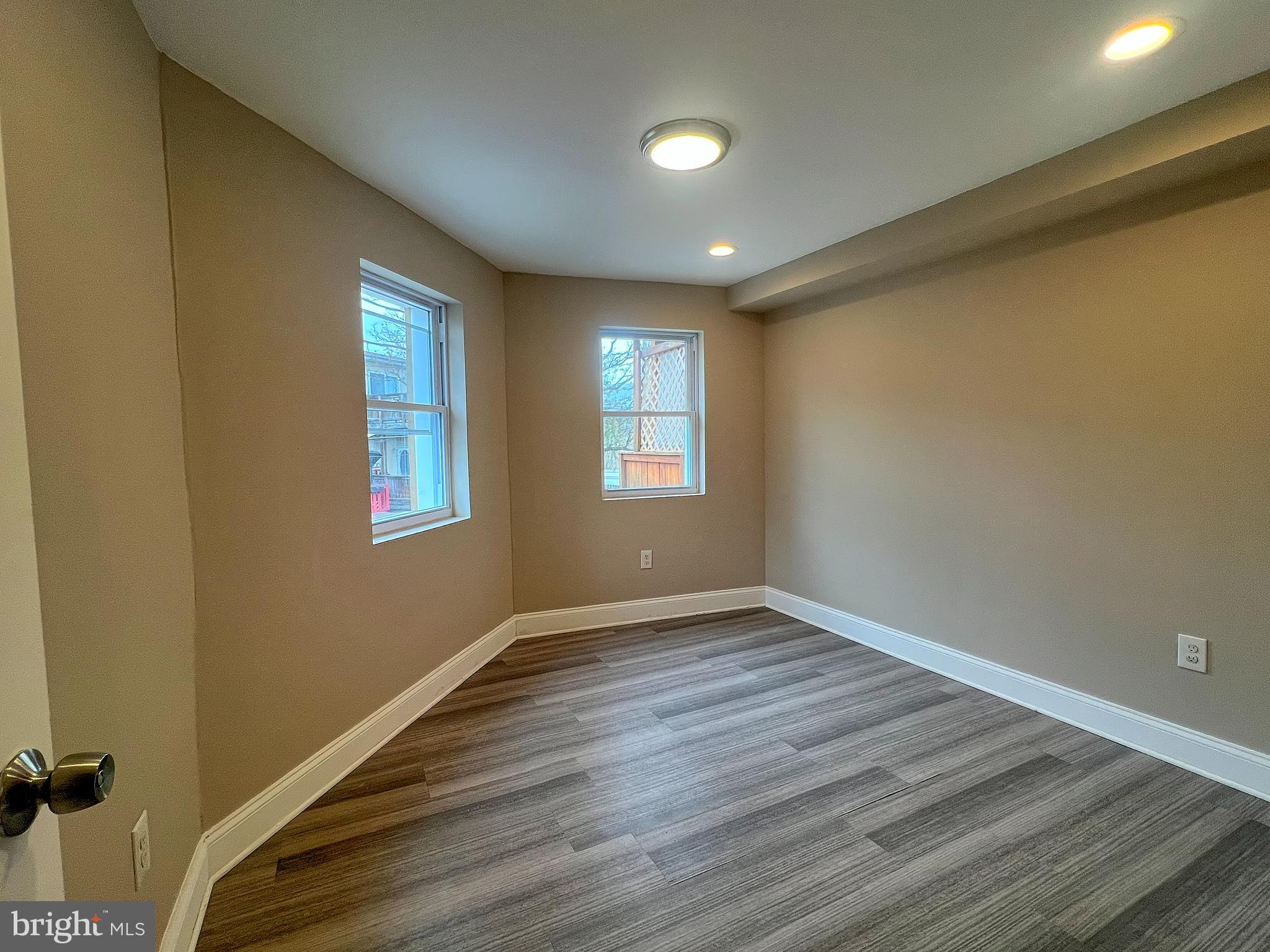 1234 West Cross Street Baltimore, MD 21230 - Photo 16 of 19 a view of an empty room with wooden floor and a window