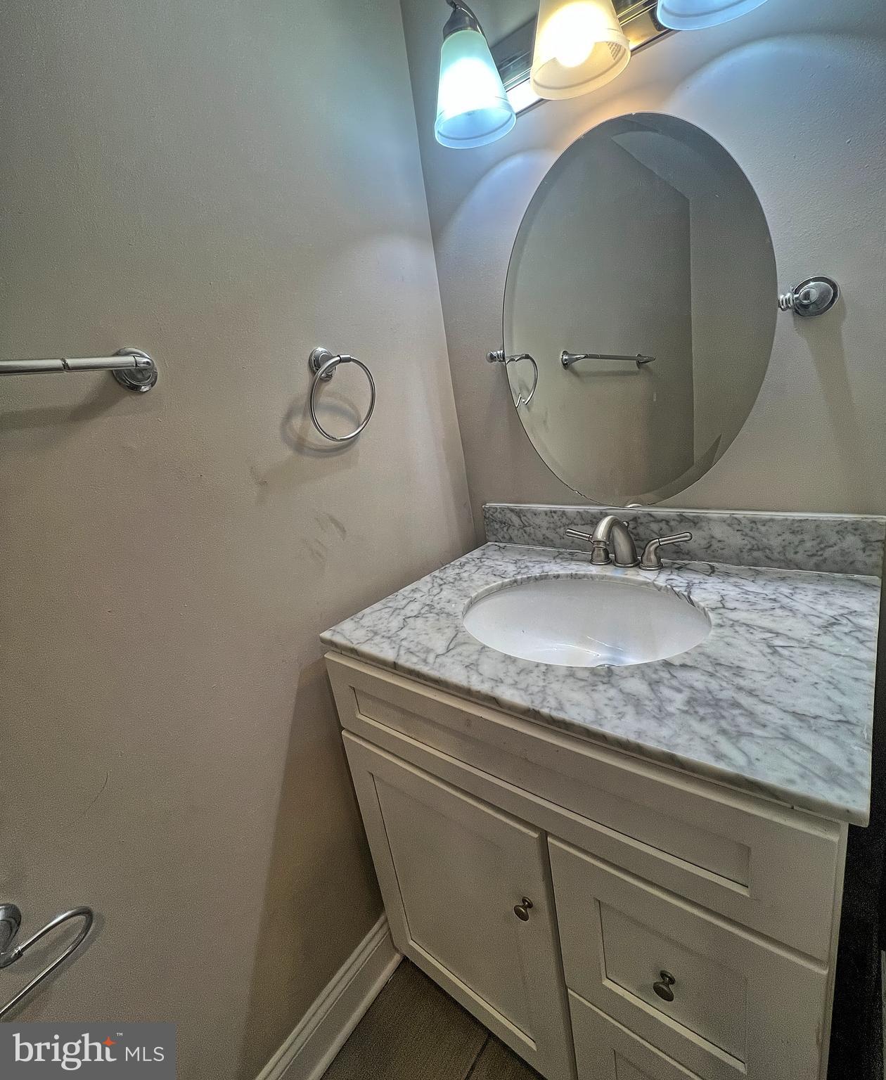 1234 West Cross Street Baltimore, MD 21230 - Photo 19 of 19 a bathroom with a granite countertop sink a mirror and vanity