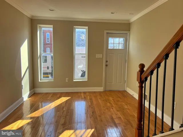 a view of an entryway with wooden floor and stairs