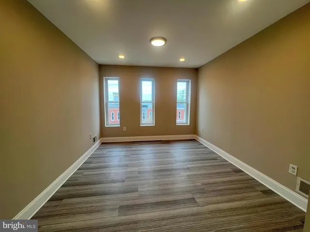 a view of an empty room and wooden floor