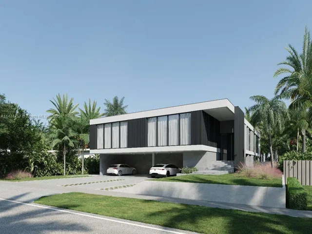 a front view of house with yard and trees in the background