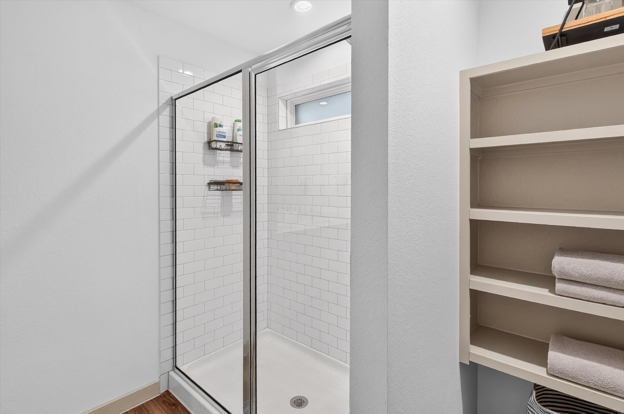 7907 Sleek Flock Lane Rosharon, TX 77583 - Photo 18 of 28 The walk-in shower is paired with built-in linen storage, keeping towels and everyday essentials close by without taking up valuable bathroom space.