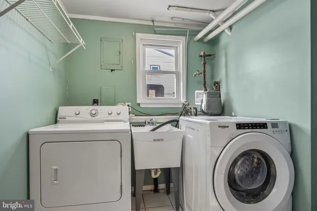 a bathroom with a toilet sink vanity and window