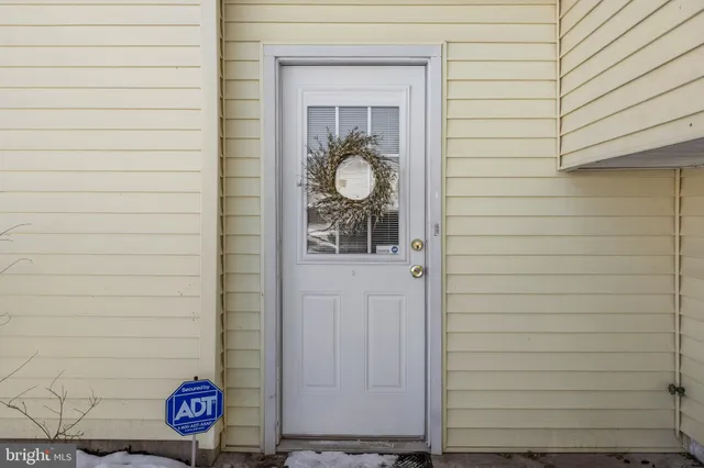 a view of door with a bench