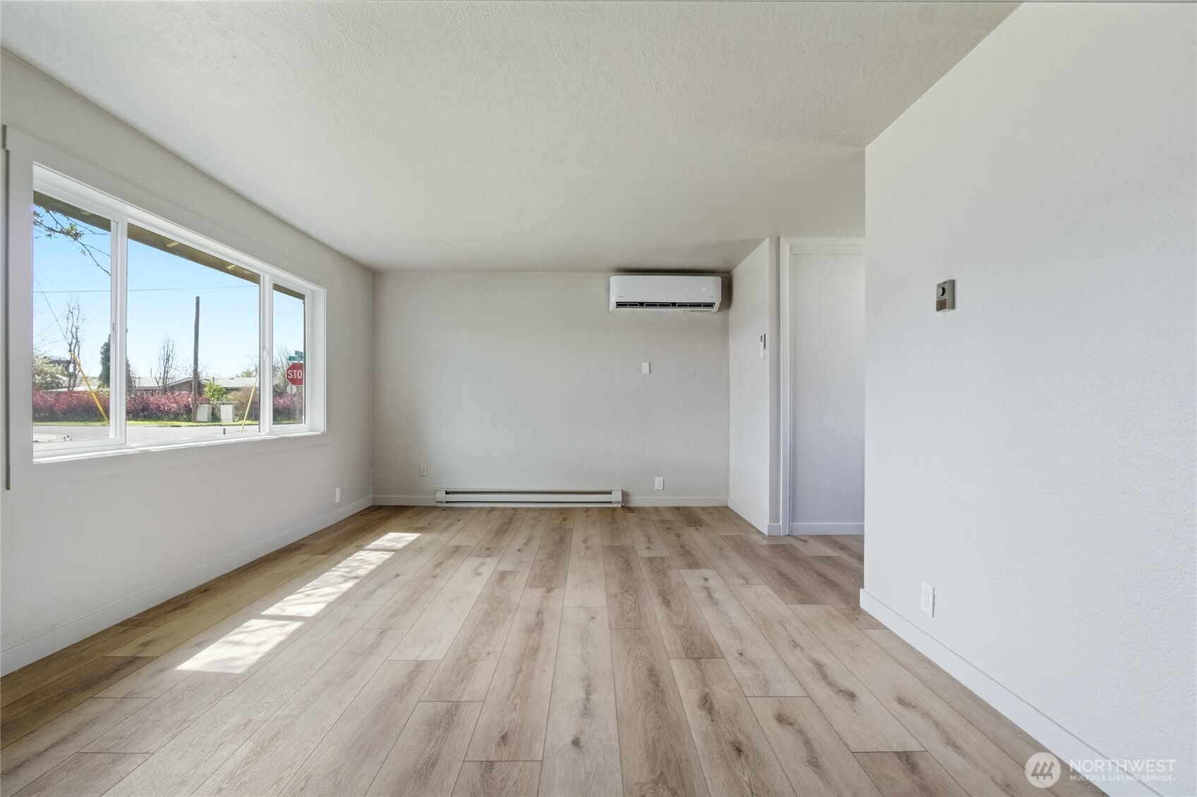 552 Edith Avenue Walla Walla, WA 99362 - Photo 4 of 19 a view of an empty room with wooden floor and a window