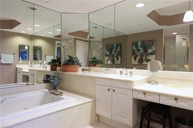 a bathroom with a sink a large mirror and a shower