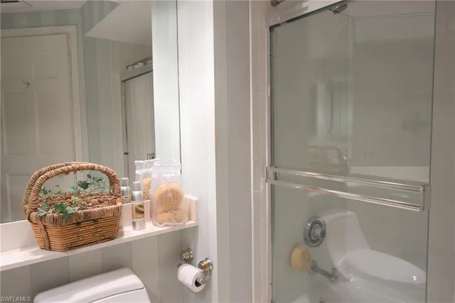 a bathroom with a toilet and a shower