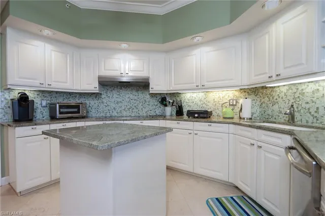 a kitchen with stainless steel appliances granite countertop a sink and cabinets