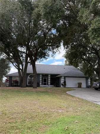 a house that has a tree in front of it