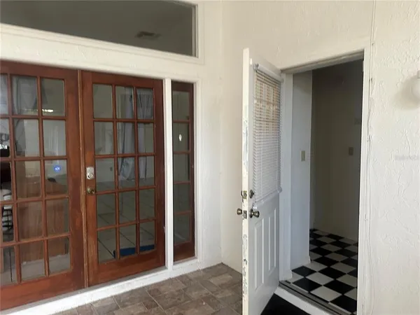 a view of a livingroom with wooden floor and a bathroom