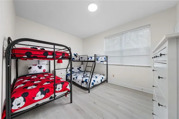 a bedroom with a bed closet and window