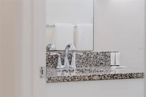 a bathroom with mirror sink and window