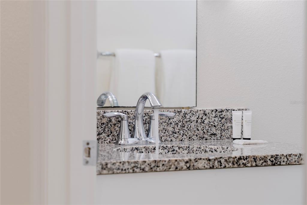 17417 Placidity Avenue Clermont, FL 34714 - Photo 18 of 25 a bathroom with mirror sink and window