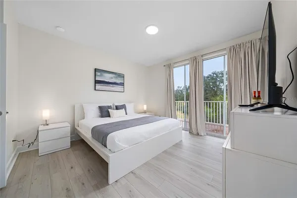 a bedroom with a large bed and a large window