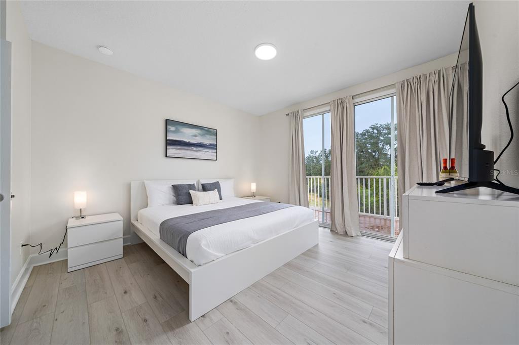 17417 Placidity Avenue Clermont, FL 34714 - Photo 21 of 25 a bedroom with a large bed and a large window