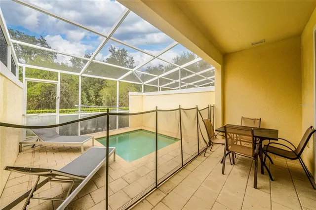 a balcony with chairs and table in the kitchen
