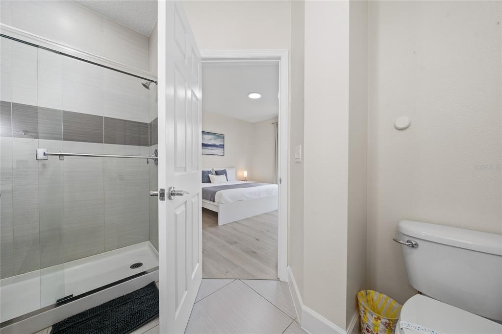 17417 Placidity Avenue Clermont, FL 34714 - Photo 24 of 25 a bathroom with a shower and toilet