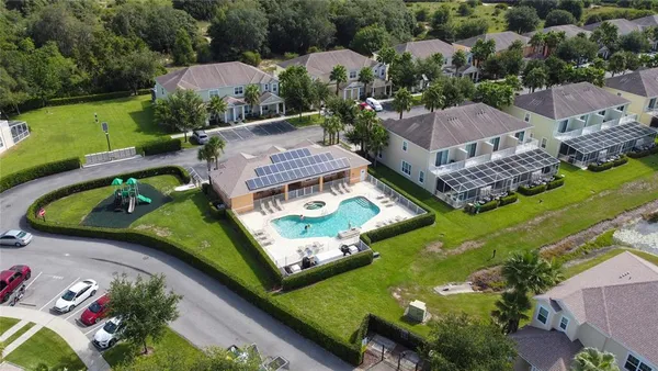 an aerial view of a house with garden space lake view and mountain view in back