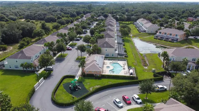 an aerial view of a house with a garden and lake view