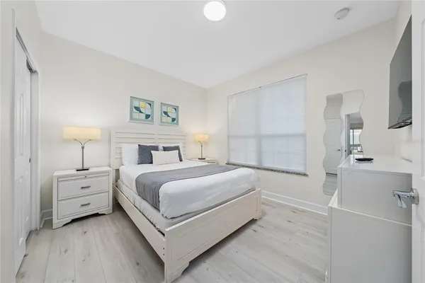 a view of a bedroom with a bed and a lamp