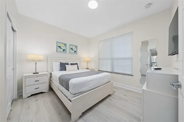 a view of a bedroom with a bed and a lamp