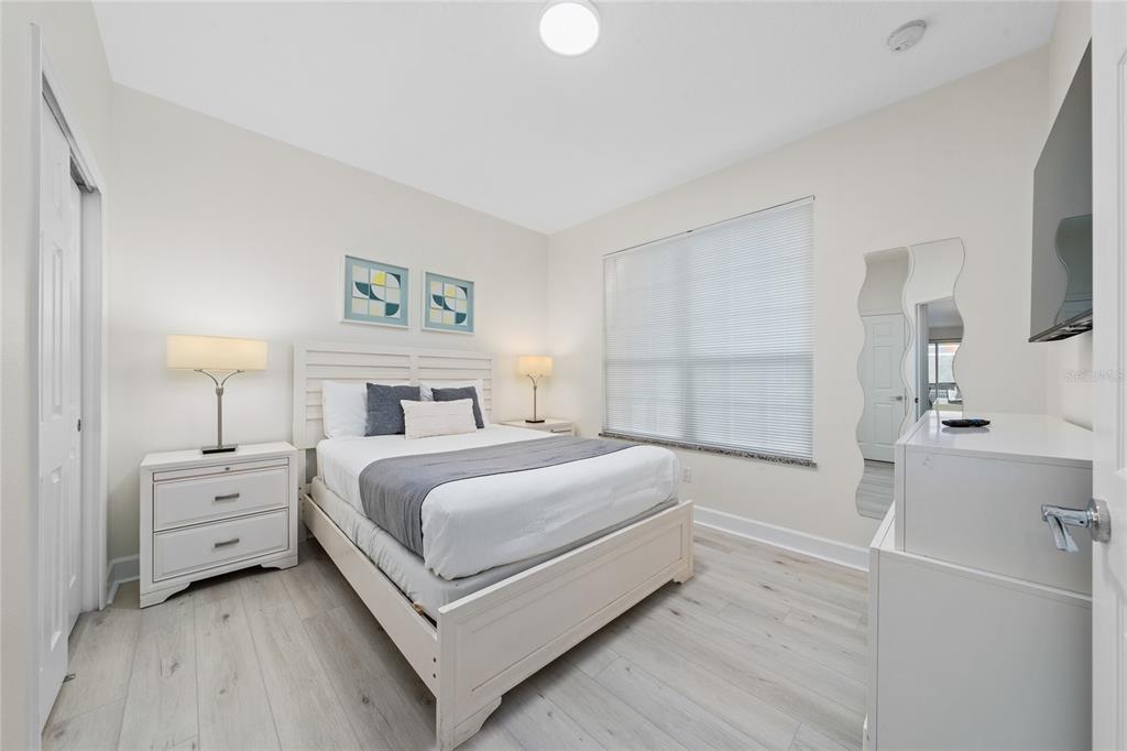 17417 Placidity Avenue Clermont, FL 34714 - Photo 9 of 25 a view of a bedroom with a bed and a lamp