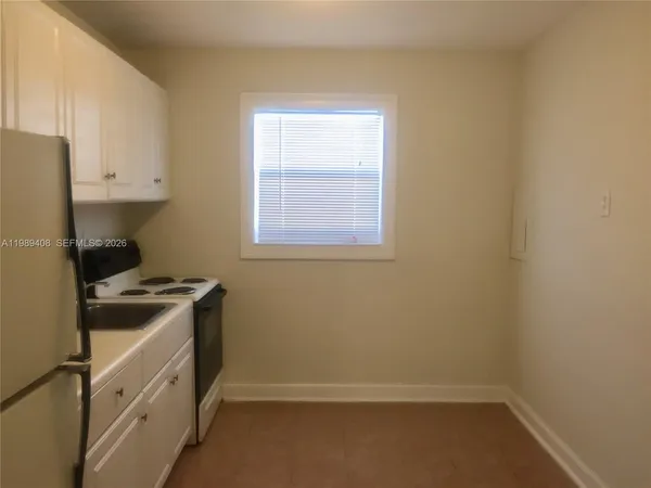 a kitchen with a stove and a window