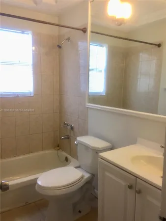 a bathroom with a toilet a sink and shower