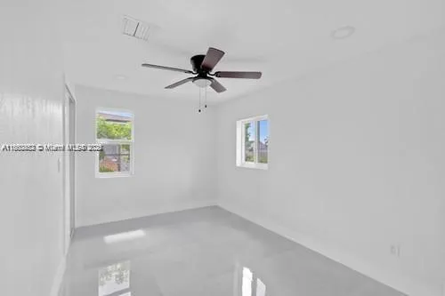 a view of a livingroom with a window and a ceiling fan