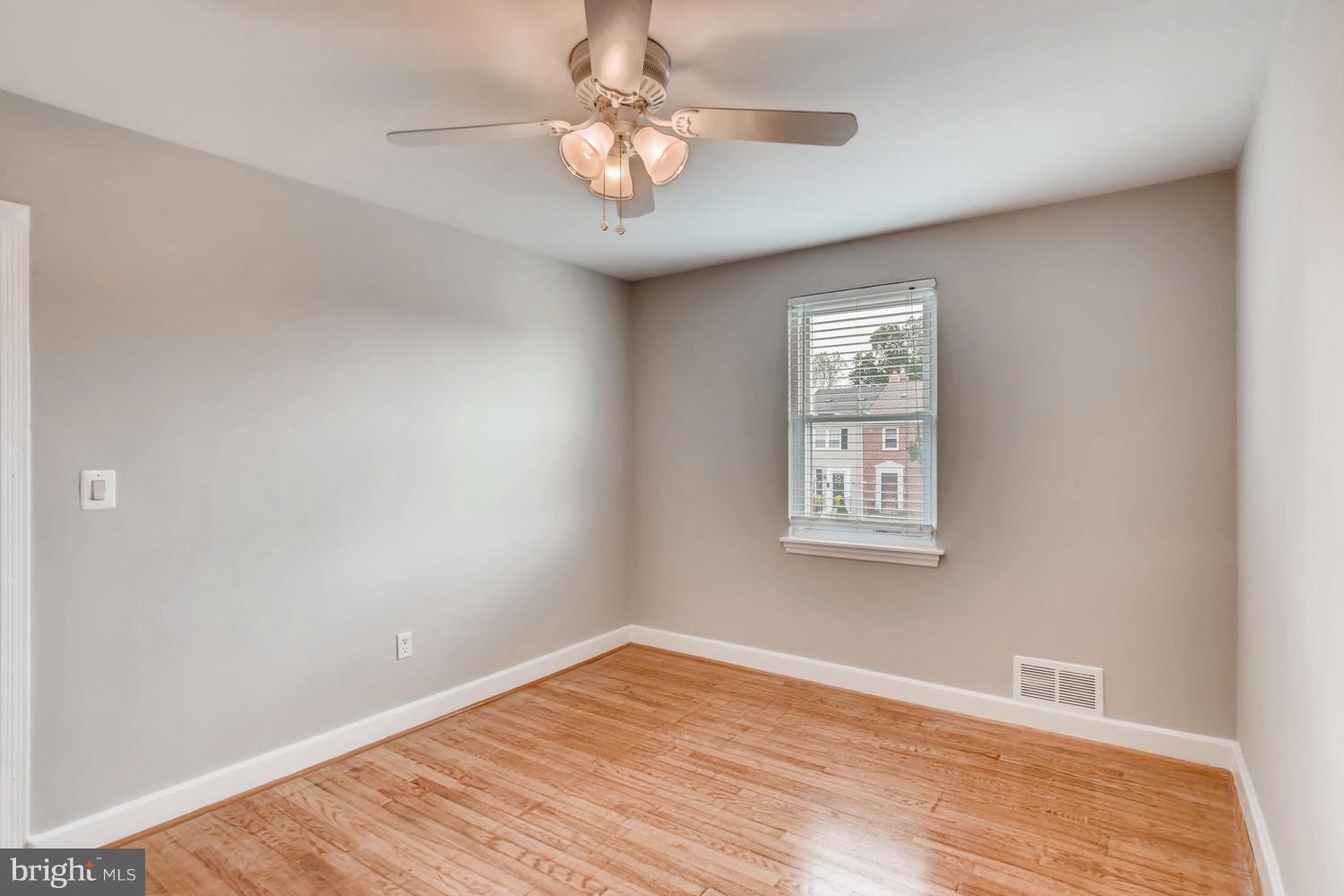 8546 Water Oak Road Baltimore, MD 21234 - Photo 12 of 28 a view of empty room with wooden floor and fan
