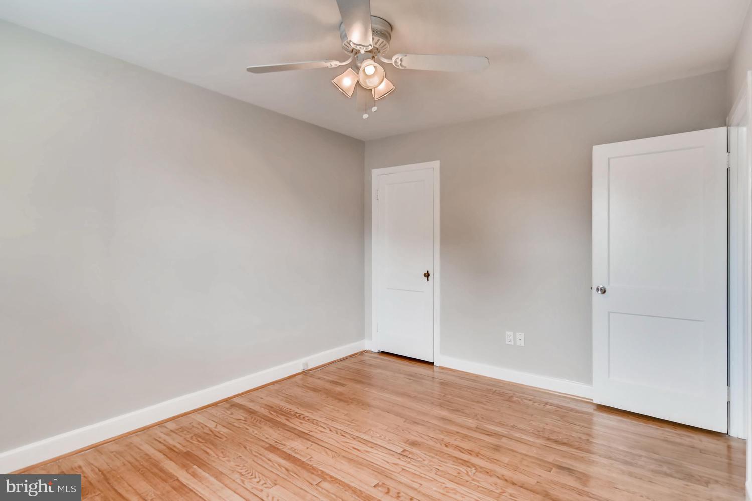 8546 Water Oak Road Baltimore, MD 21234 - Photo 14 of 28 a view of a room with wooden floor and a ceiling fan
