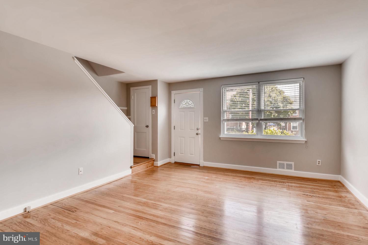 8546 Water Oak Road Baltimore, MD 21234 - Photo 4 of 28 a view of an empty room with wooden floor and a window