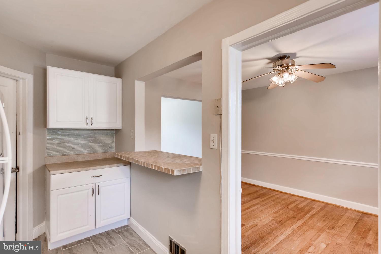 8546 Water Oak Road Baltimore, MD 21234 - Photo 8 of 28 a view of a kitchen with a sink and dishwasher with wooden floor