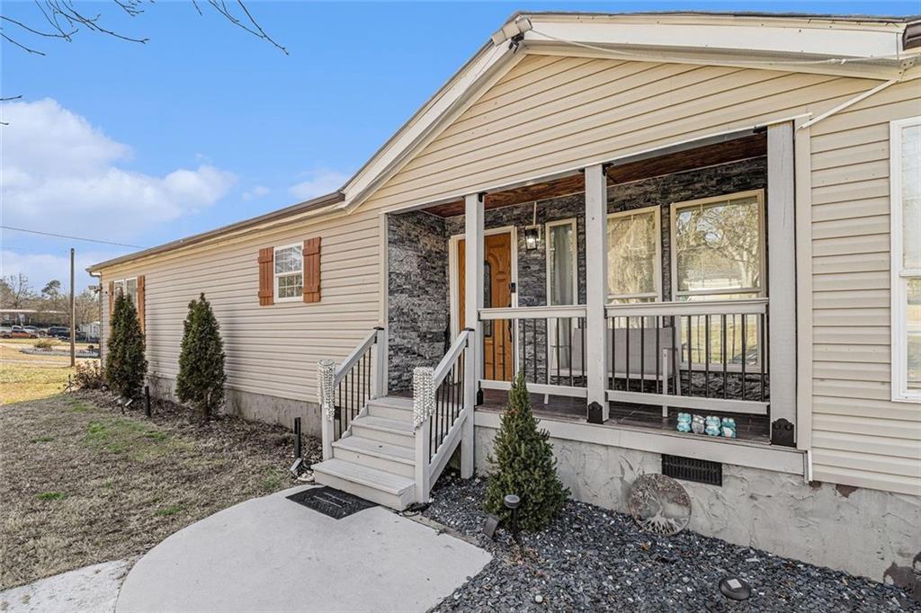 a view of a house with a yard and wooden fence