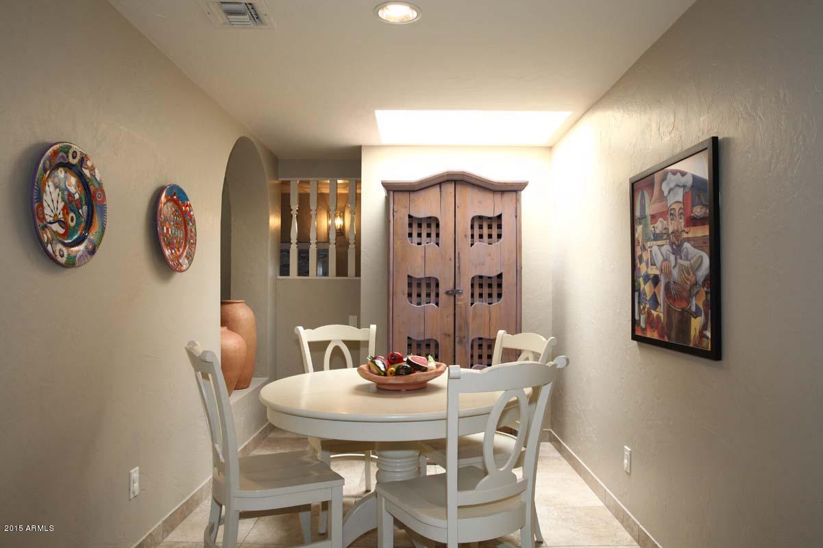 7249 East Maverick Road Scottsdale, AZ 85258 - Photo 12 of 26 a view of a dining room with furniture and a wall painting