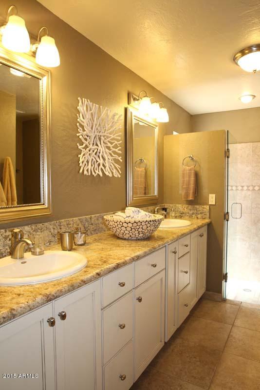 7249 East Maverick Road Scottsdale, AZ 85258 - Photo 18 of 26 a bathroom with a granite countertop sink and a mirror