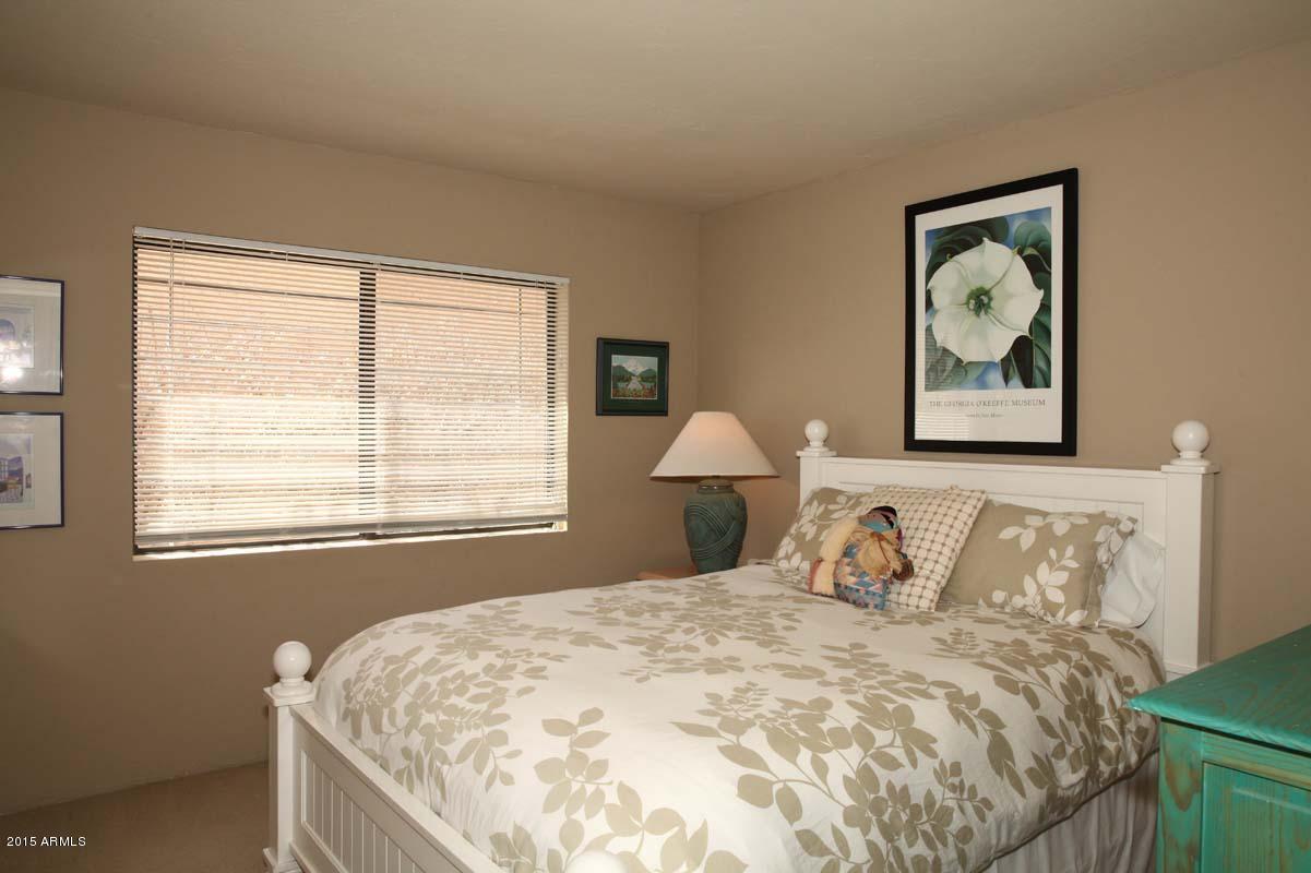 7249 East Maverick Road Scottsdale, AZ 85258 - Photo 22 of 26 a bedroom with a bed and a painting on the wall