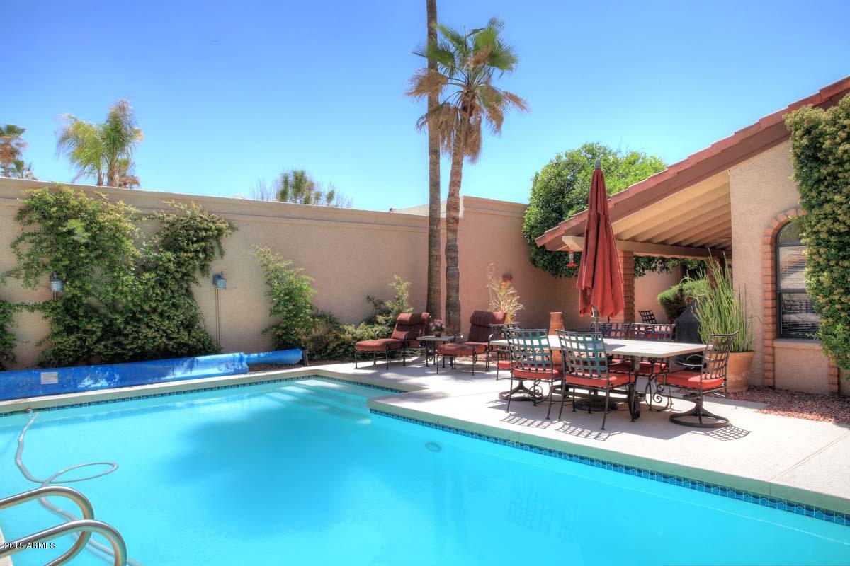 7249 East Maverick Road Scottsdale, AZ 85258 - Photo 3 of 26 a view of swimming pool with lawn chairs and plants