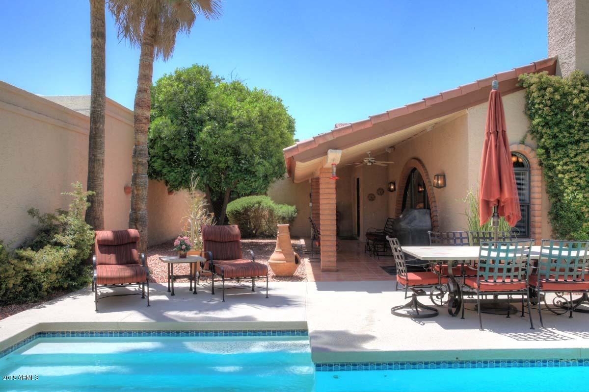 7249 East Maverick Road Scottsdale, AZ 85258 - Photo 5 of 26 a building outdoor space with patio furniture and potted plants