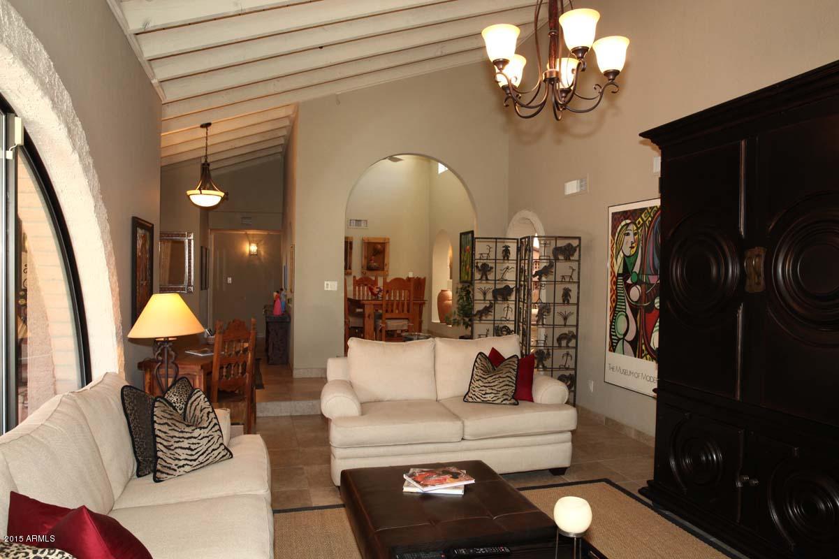 7249 East Maverick Road Scottsdale, AZ 85258 - Photo 10 of 26 a living room with furniture and a chandelier