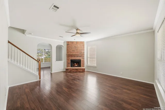 wooden floor in an empty room with a fireplace