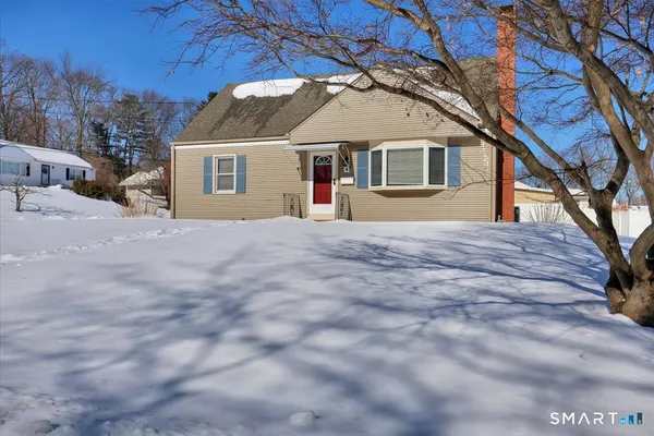 a house that has a tree in front of it