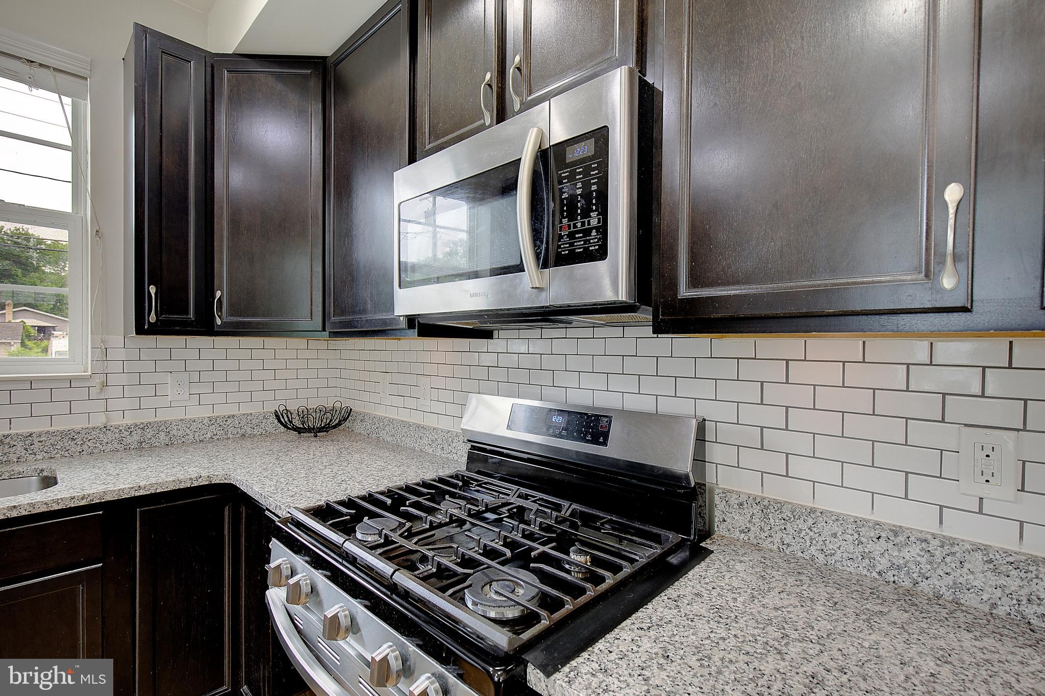403 Venton Road Edgewater, MD 21037 - Photo 22 of 62 a kitchen with stainless steel appliances a stove a microwave and sink