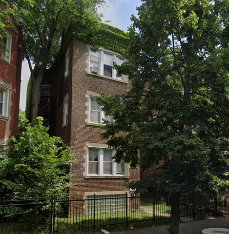 front view of a house with a tree