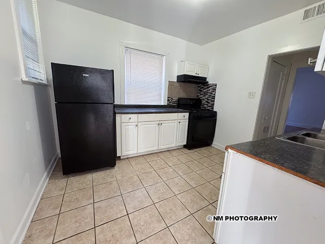 a kitchen with a refrigerator and a stove
