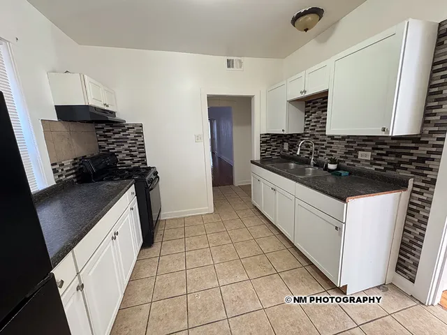a kitchen with a sink a stove and refrigerator