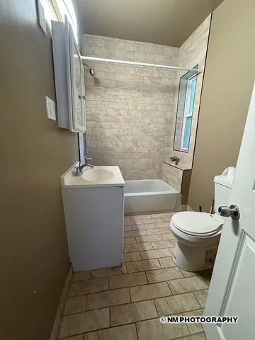 a bathroom with a toilet a sink and bathtub