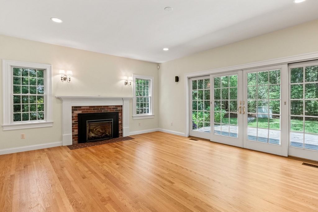 5 Main Sail Drive Sandwich, MA 02644 - Photo 7 of 33 a view of empty room with wooden floor and fireplace