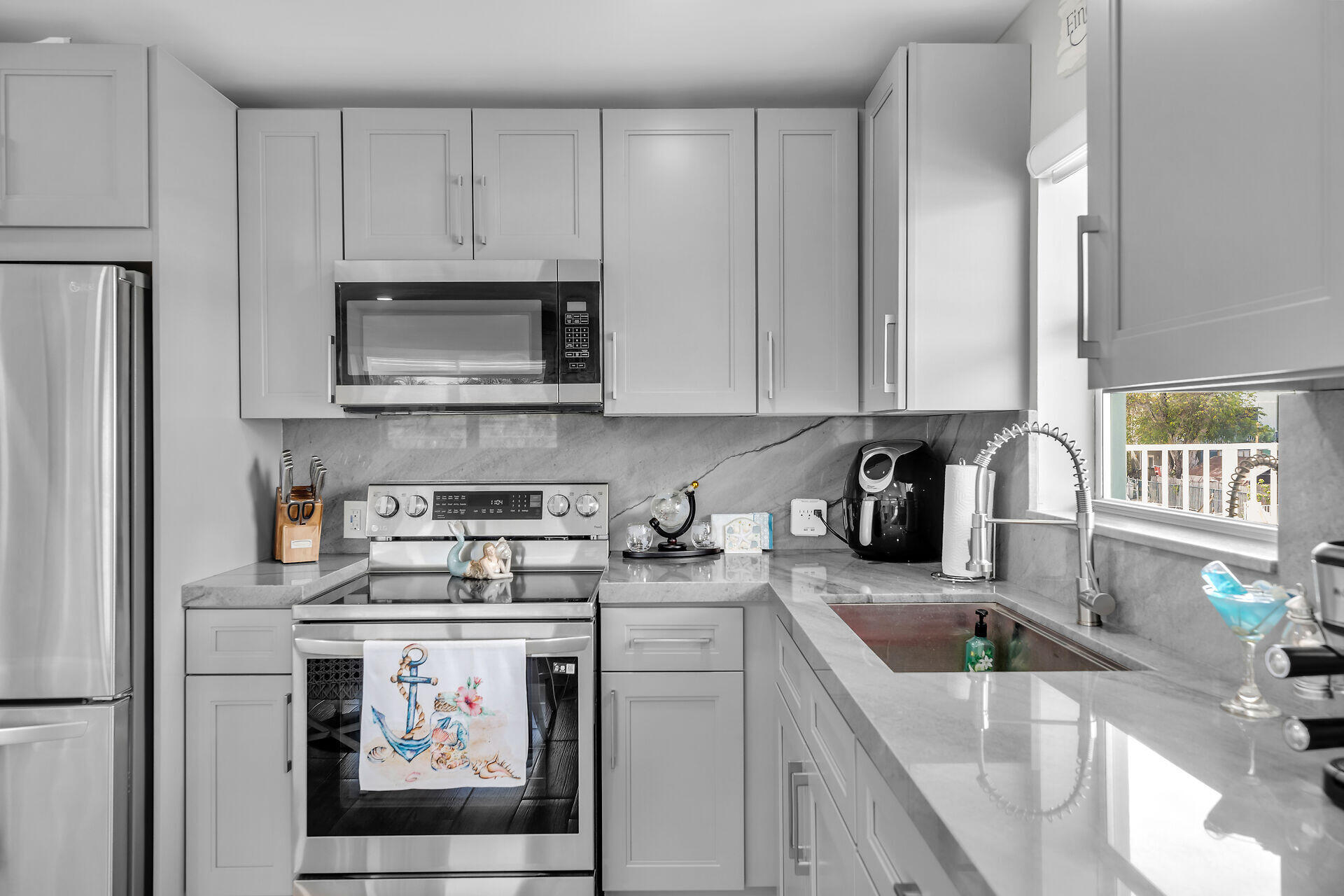1007 Hialeah Lane Key Largo, FL 33037 - Photo 18 of 41 a kitchen with stainless steel appliances granite countertop a sink stove and cabinets