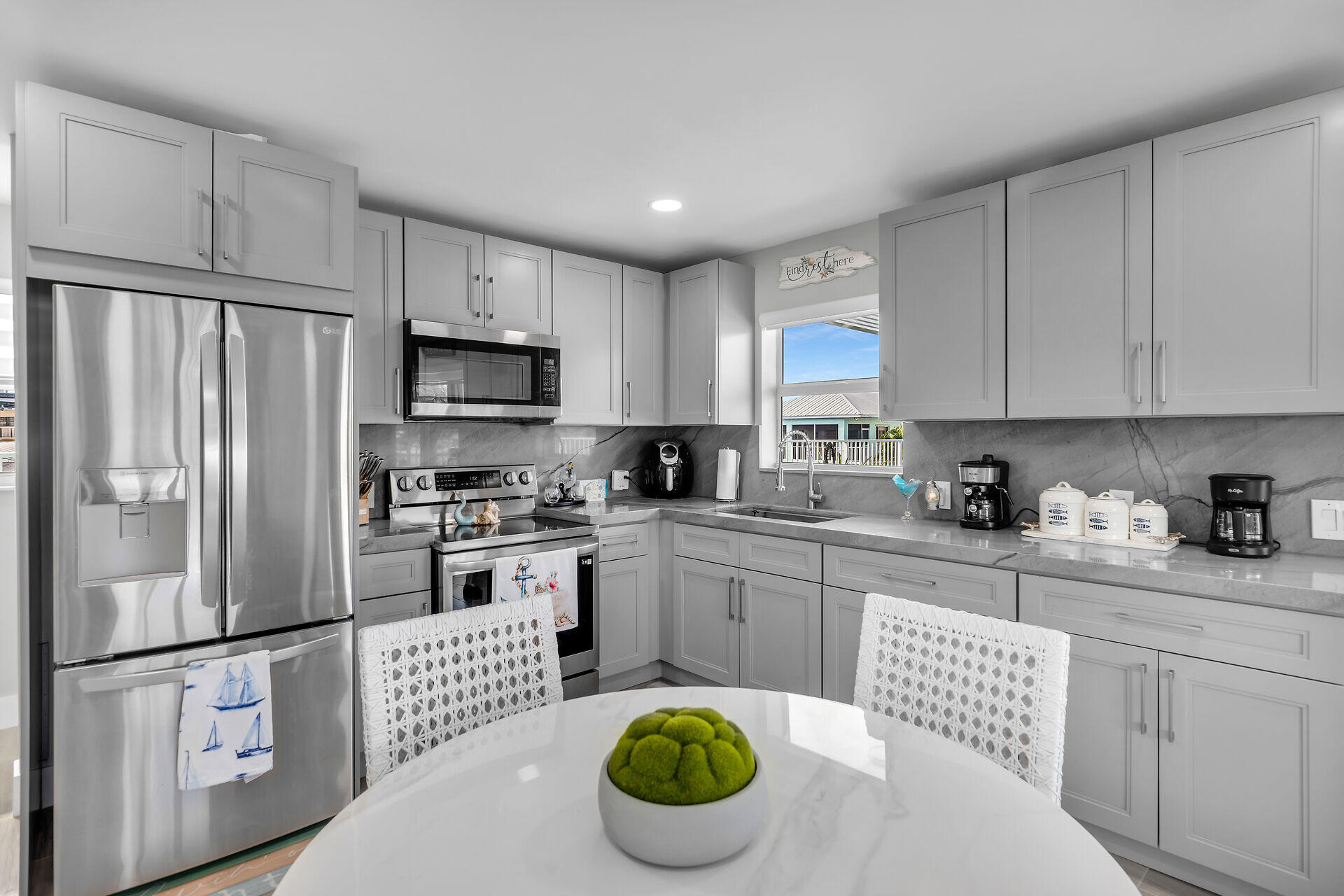 1007 Hialeah Lane Key Largo, FL 33037 - Photo 21 of 41 a kitchen with granite countertop a sink stainless steel appliances and refrigerator